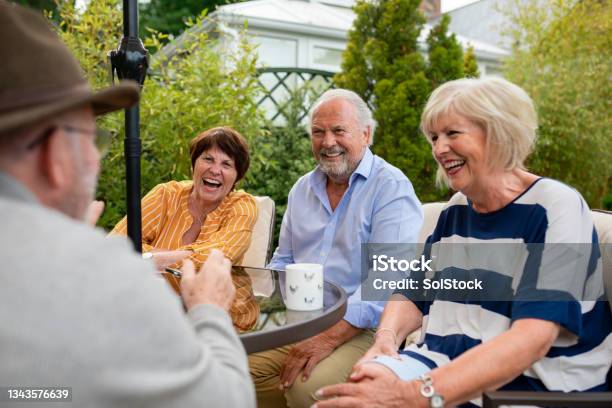 Friends Having A Laugh In The Garden Stock Photo - Download Image Now - Senior Adult, Friendship, Community