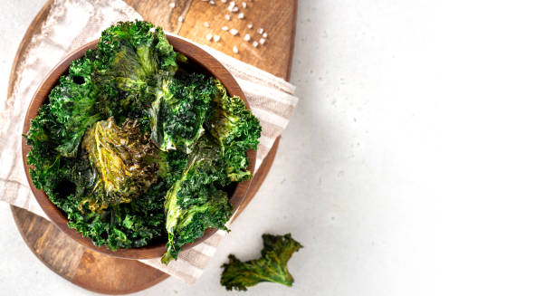 Baked kale chips in a wooden bowl