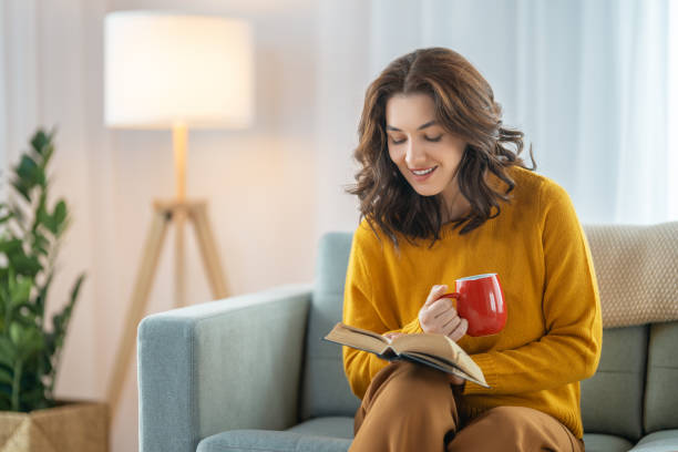 istock woman enjoying book and tea 1343585576