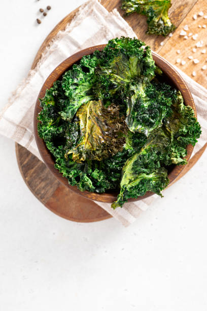 istock Baked kale chips in a wooden bowl 1343585668