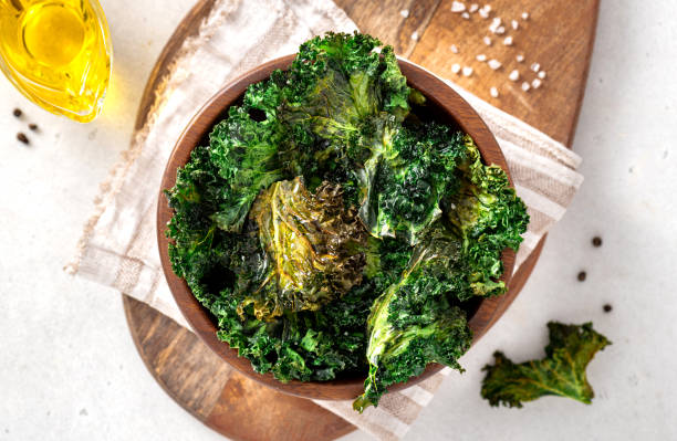 istock Baked kale chips in a wooden bowl 1343585669