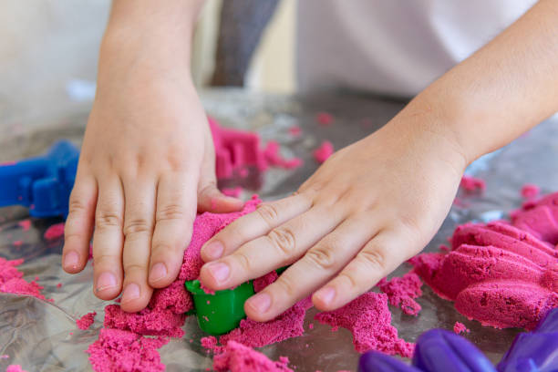 istock Closeup of child's hands playing in kinetic sand 1343585802