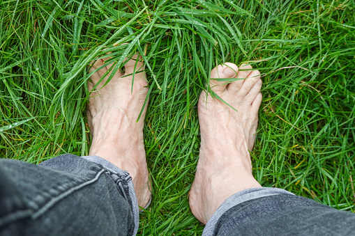 Walking barefoot through the damp grass