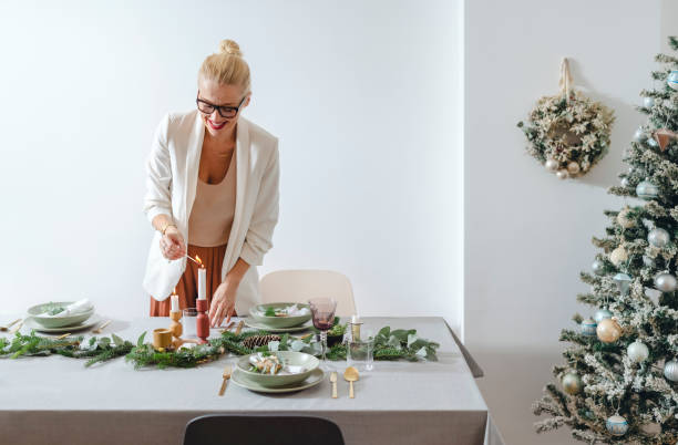 istock Christmas Celebration: Cheerful Woman Setting Up Christmas Dinner Table 1343587143