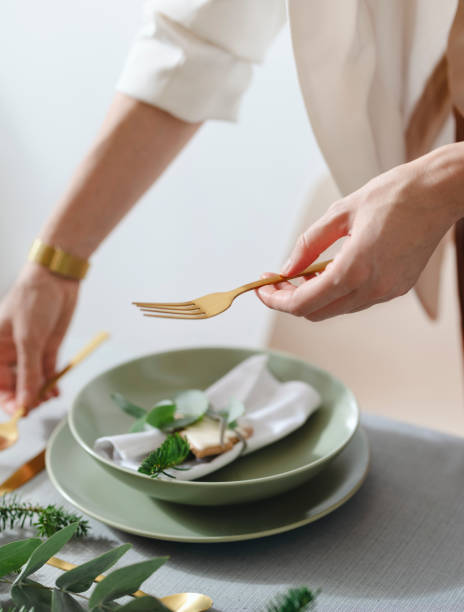 istock An Anonymous Woman Setting Up Christmas Dinner Table 1343587167