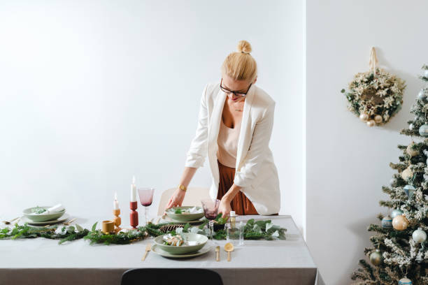 istock Christmas Preparation: Cheerful Woman Setting Up Christmas Dinner Table 1343587177