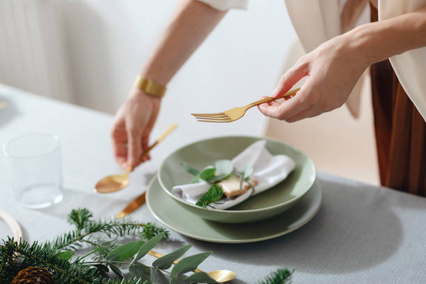 istock Christmas Preparation: An Anonymous Woman Setting Up Christmas Dinner Table 1343587180