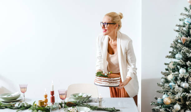 istock New Year's Eve Preparations: Happy Woman Setting Up Christmas Dinner Table 1343587190