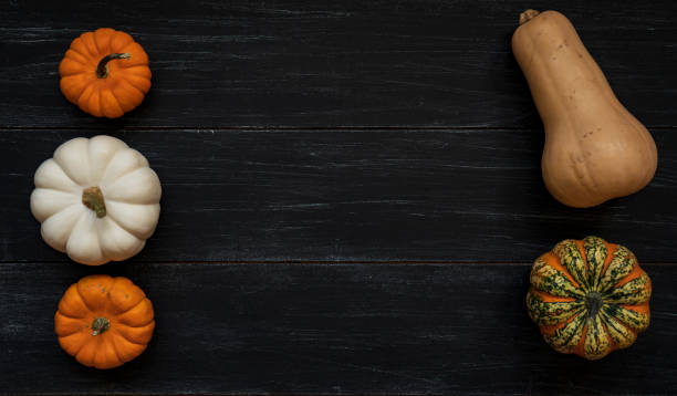 istock Pumpkins on wooden background 1343587579