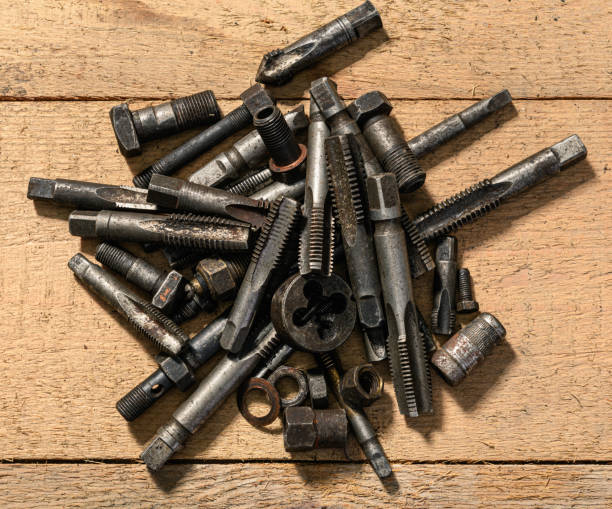 istock Old vintage hand tools - drills and threading die on a wooden background 1343592642