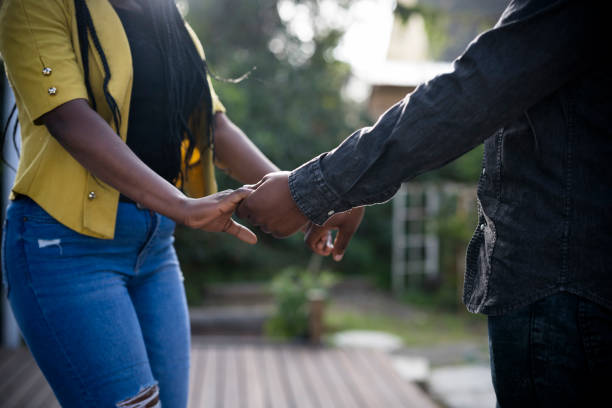 istock Side view young African couple holding each others hands 1343594381