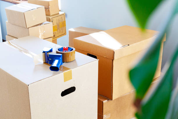 istock House moving concept with stacked cardboard boxes in a room 1343596717