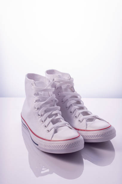 istock white sneakers with a red stripe on a white background in the reflection 1343597042