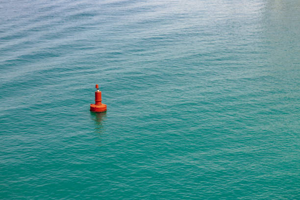 istock Single red buoy in the clear sea 1343598595
