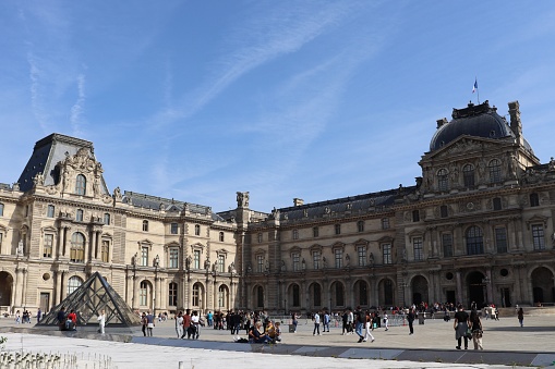 Paris, France - September 26, 2021: People at the Arc de Triomphe du Carrousel near the Louvre.