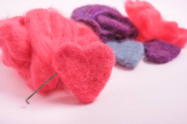 several multi-colored felted woolen hearts, romantic DIY decor, copy space close up