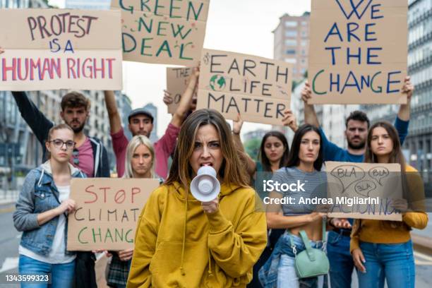 Group Of Multiethnic People Making Protest About Climate Change Public Demonstration On The Street Against Global Warming And Pollution Stock Photo - Download Image Now