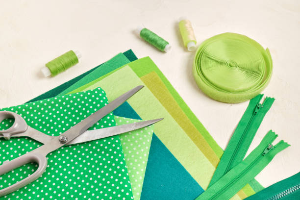 istock felt, accessories for sewing and needlework on the table, shades of green 1343600493