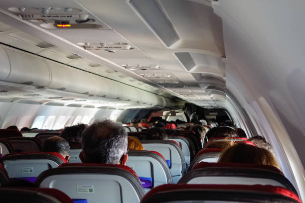 istock airplane interior view, aisle, chairs and ceiling 1343602567