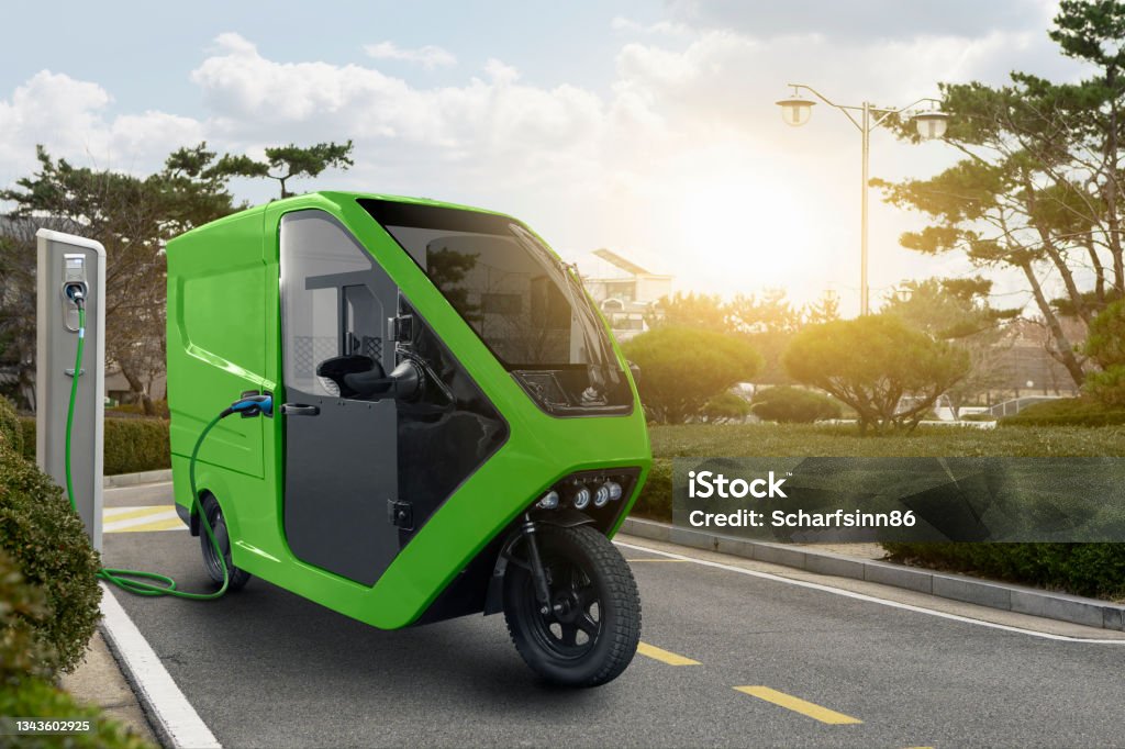 Concept of delivery electric tricycle scooter Concept of delivery electric tricycle scooter with charging station on city street Electricity Stock Photo