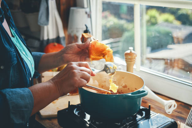 Preparing Pumpkin Soup with Bacon and Thyme Preparing Pumpkin Soup with Bacon and Thyme squash soup stock pictures, royalty-free photos & images