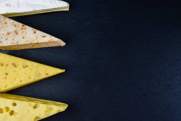 various types of cheese on a slate board. top view - dairy farm dairy product emmental cheese cheese imagens e fotografias de stock