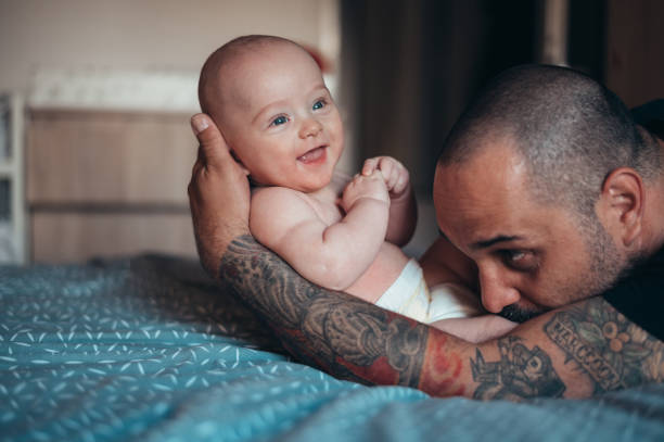 istock Tattooed bearded father playing with his son 1343609288