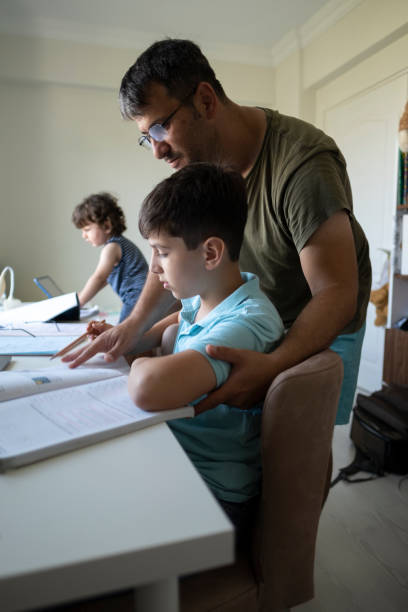 istock Little boys attending to online class in his room. 1343609852