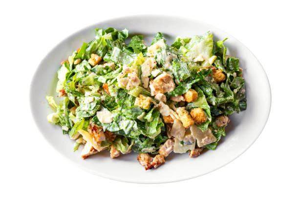 istock Fresh healthy caesar salad on white plate isolated on white background. 1343612452