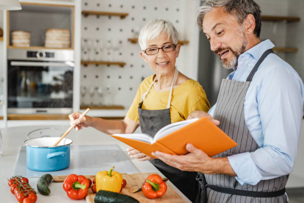 istock Mature couple preparing dinner at home 1343612643