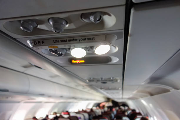 istock airplane interior view, aisle, chairs and ceiling 1343612680