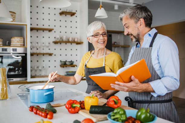 istock Mature couple preparing dinner at home 1343613895