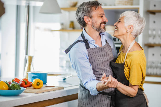 istock Romantic mature couple, dancing in the kitchen 1343614407