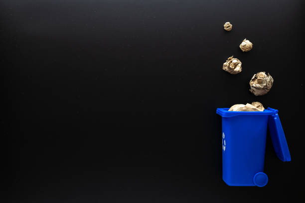 istock Recycled paper. Blue dustbin for recycle plastic and glass can trash on black background. Bin container for disposal garbage waste and save environment. Copy space. 1343615145