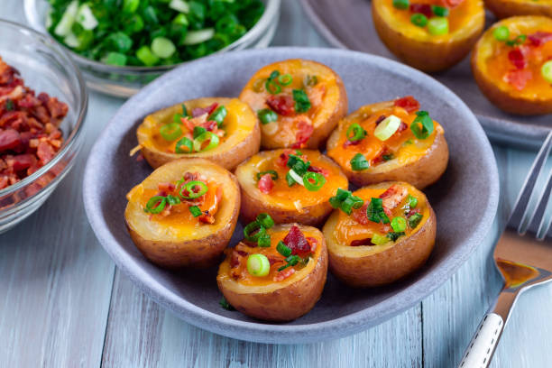 istock Baked mini red skinned loaded potatoes with crispy bacon, scallions and sharp cheddar cheese, closeup 1343615875