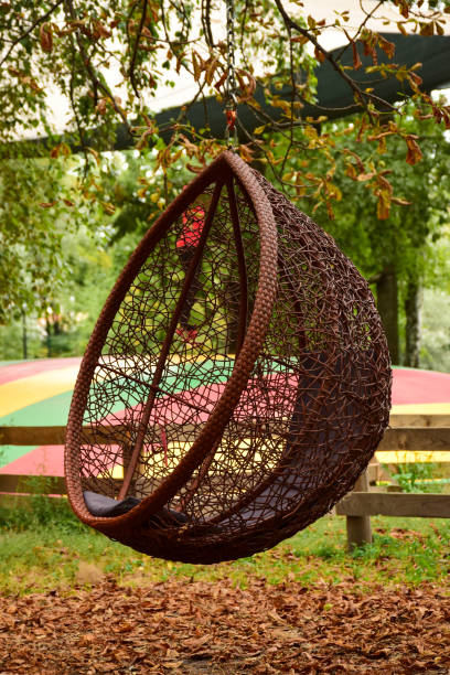 istock A decorative resting place in the form of a wicker swing hanging from a tree 1343617622