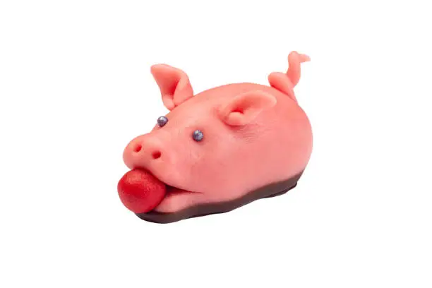 Traditional scandinavian marzipan pig with red apple, lucky symbol for Christmas, isolated on a white background