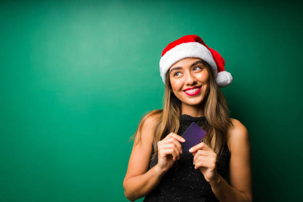 Cheerful woman planning to buy gifts stock photo