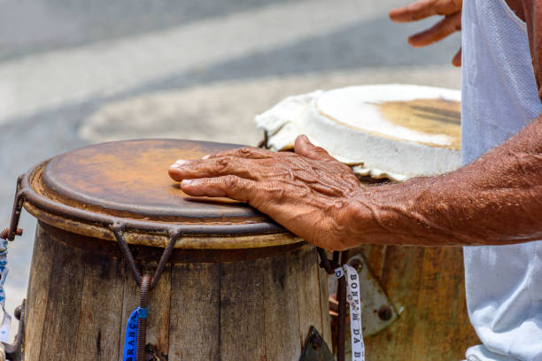 musician playing a traditional brazilian percussion instrument called atabaque during a capoeira performance - pelourinho imagens e fotografias de stock