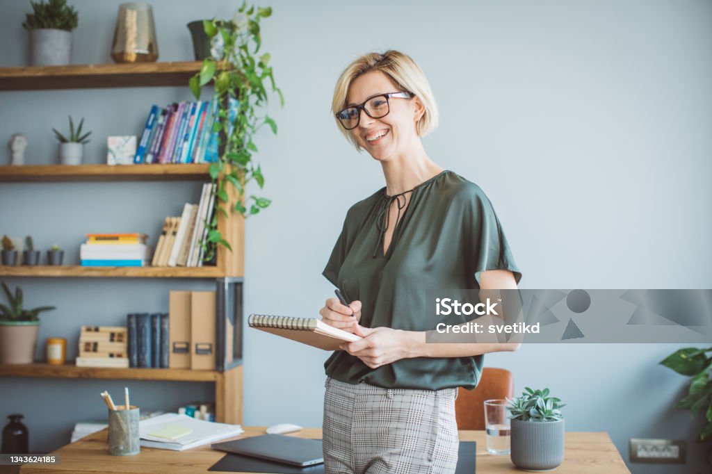 Author on meeting with publisher Young woman at office on meeting. She is book author and talking with publisher. Publisher Stock Photo