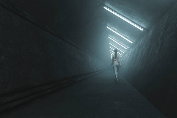 Girl Silhouette raning through empty, dark tunnel.Symbolizing escape, looking for exit or freedom