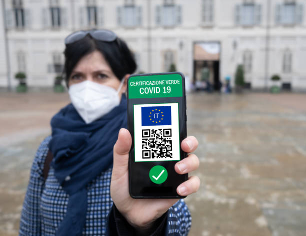 istock Young Italian woman holding smartphone with Green Pass QR code confirm vaccination coronavirus covid-19. Vaccine done with passport 1343626449