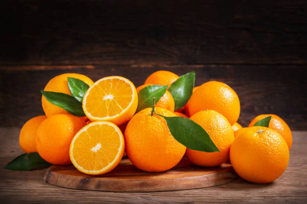 istock fresh orange fruits on a wooden background 1343628832