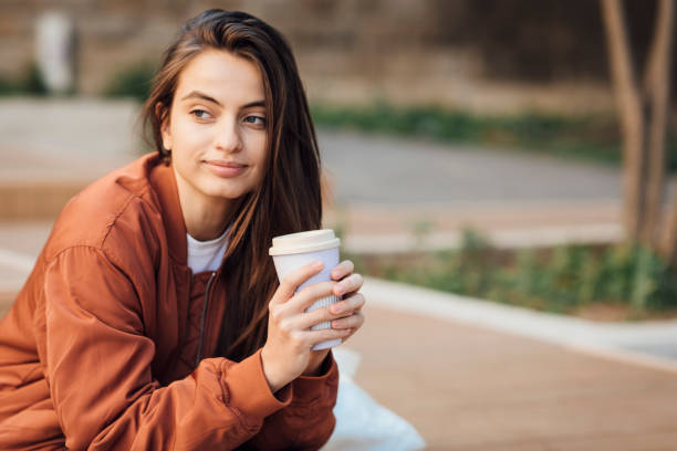 istock Girl with coffee cup 1343631947