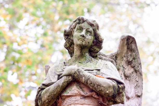 istock Angel, weathered old statue of angle, background with copy space 1343639160