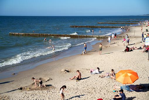 Zelenogradsk, Kaliningrad region, Russia - June 14, 2021: Unknown people resting and sunbathing on a sandy beach on the Baltic Sea coast in famous resort Zelenogradsk (formerly known as Cranz) at summer time
