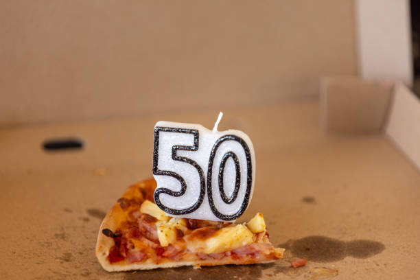 50th birthday candle on leftover pizza - time for a change of diet.