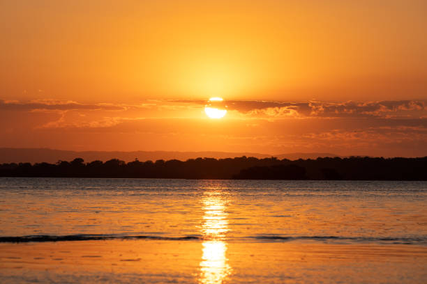 Watching the sun set in the Pantanal of Brazil is always a feast for the eyes.  As the sun disappears behind the forest it is reflected in the slow moving river and saturates the sky with orange and red hues.