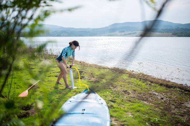 istock Woman Pumping Stand Up Paddle Board 1343651272
