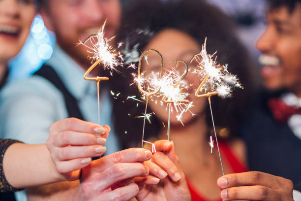 istock Smiling people holding sparklers 1343651316